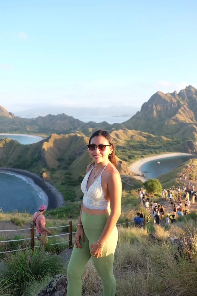 A traveler enjoying the breathtaking panoramic view from the top of Padar Island