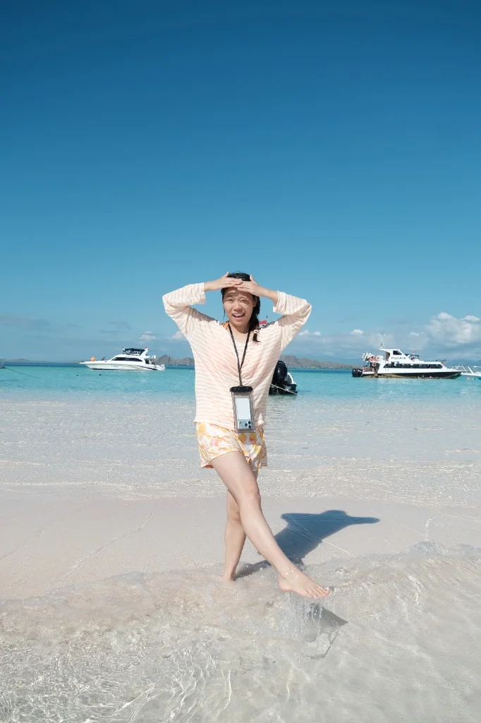 A happy traveler enjoying the pristine beaches of Komodo National Park