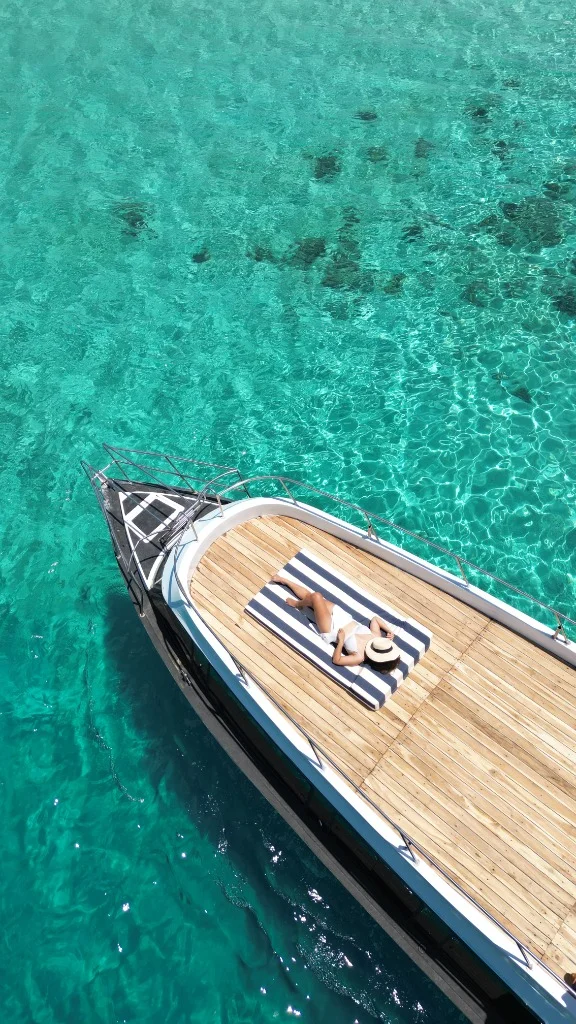 Aerial view of Speedboat D deck in crystal clear turquoise water of Komodo National Park